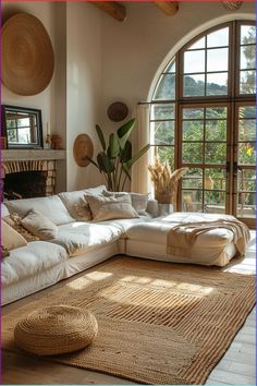 a living room filled with furniture and large windows