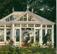 a white house sitting in the middle of a garden