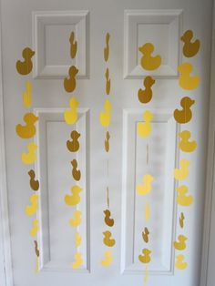 the door is decorated with gold foil ducks and streamers hanging from it's sides