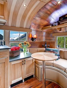 the interior of a motor home with wood paneling and wooden flooring is shown