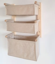 three canvas storage bins hanging on the wall