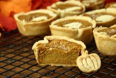 pumpkin pies cooling on a rack in the oven