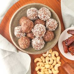 nuts, raisins and chocolate in a bowl on a wooden table