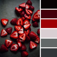 some strawberries are laying next to each other on a table with color swatches