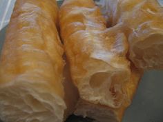 two large pieces of bread sitting on top of a plastic container next to each other