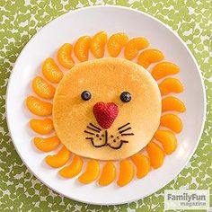 a lion made out of orange slices on a plate