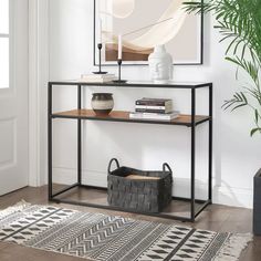 a black metal and wood console table in a living room