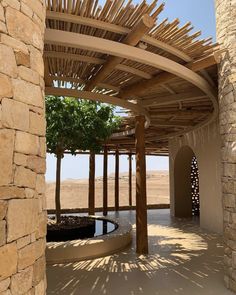 an outdoor area with stone walls and wooden structures