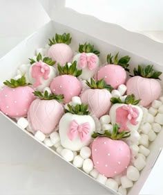 a box filled with pink and white chocolate covered strawberries