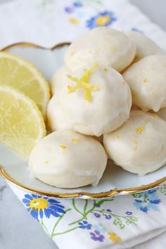 lemon meringue cookies on a plate with a slice of lemon