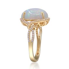 an opal and diamond ring in yellow gold with diamonds on the sides, set against a white background