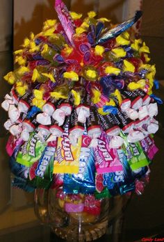 a vase filled with candy and candies on top of a table