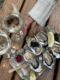 several oysters on the half shell and two glasses of wine