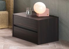 a night stand with a light on top of it