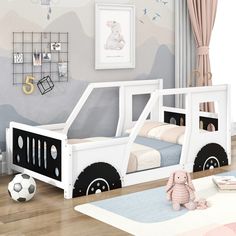 a child's bedroom with a white bed frame and black wheels