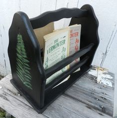 a book holder with books on it sitting on a wooden bench