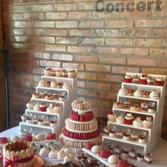 a table topped with lots of different types of cakes and cupcakes on top of it