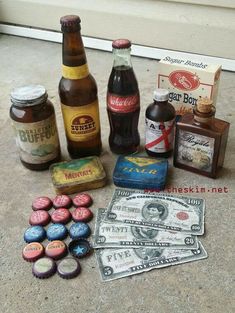 an assortment of beer bottles and money on the ground next to a window sill