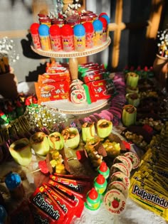 an assortment of candy and candies on a table with two tiered trays