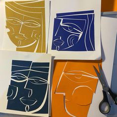 four pieces of paper cut out with scissors on top of them, each depicting different faces