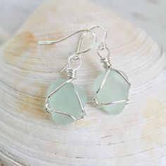 sea glass and sterling wire earrings on a seashell