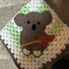 there is a crocheted bear on the blanket