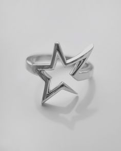 The Rock Star Ring is a bold and edgy piece, inspired by the iconic asymmetrical designs seen in Lisa’s “Rockstar” music video. Crafted from premium 925 sterling silver, this ring features a striking open star design. Its unique asymmetrical shape adds a touch of rebellious elegance, making it a perfect accessory for those who love to stand out. Embrace your inner rockstar and let this ring be a statement of your unique style and fearless spirit. Cheap Adjustable Star Shaped Ring, Adjustable Star-shaped Edgy Jewelry, Adjustable Edgy Star-shaped Jewelry, Luxury Silver Star-shaped Ring, Spiritual Silver Star-shaped Rings, Edgy Jewelry, Anime Expo, Star Ring, Asymmetrical Design