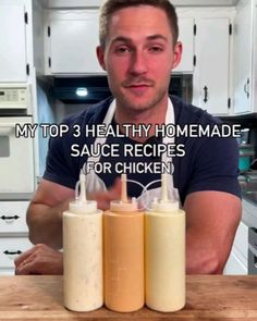 a man sitting at a kitchen counter with three sauce bottles in front of him and the words my top 3 healthy homemade sauce recipes for chicken