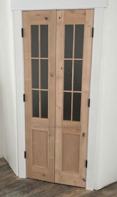 two wooden doors sitting next to each other on top of a hard wood flooring