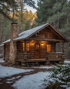 a log cabin in the woods with snow on the ground