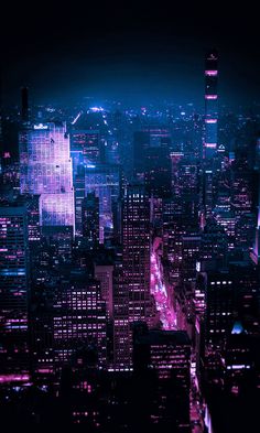 an aerial view of the city at night with bright lights and skyscrapers in the background