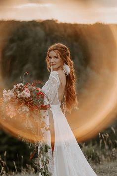 a woman in a white wedding dress holding a bouquet