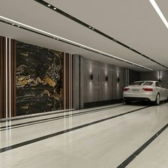 a car is parked in the middle of an empty parking garage with marble walls and flooring