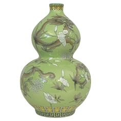 a large green vase with designs on it