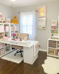 a room filled with lots of white furniture and shelves next to a window covered in pink flowers