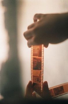 a person holding a film strip in their hand