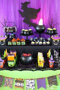 a table topped with lots of halloween treats