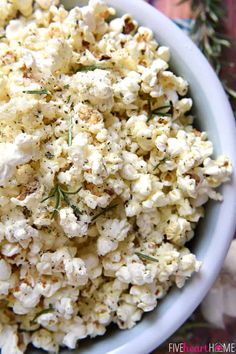 a white bowl filled with cheese and herbs