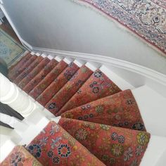 the stairs are lined with colorful rugs