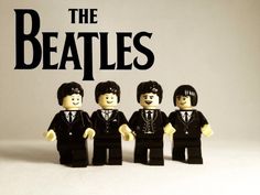 the beatles lego minifigures are standing in front of an advertisement for their album