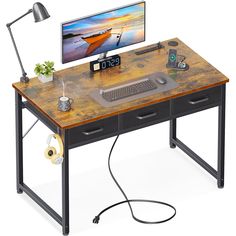 a computer desk with a monitor, keyboard and mouse