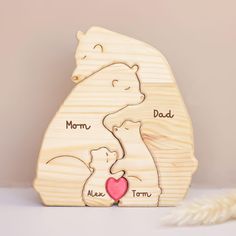 a wooden bear and her cub are shown with the word mom, dad written on it