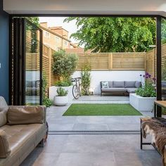 an open living room with sliding glass doors leading to the outside patio and garden area