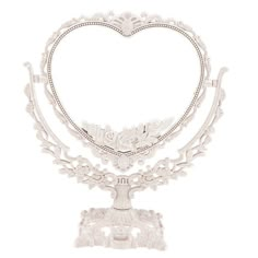 a white heart shaped cake stand on a white background