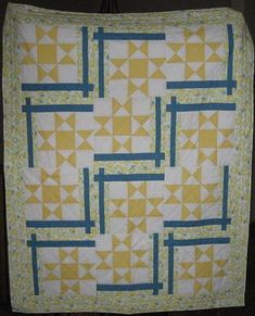 a yellow and blue quilt with squares on it