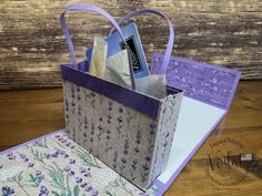 an open purse sitting on top of a wooden table