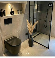 a bathroom with a toilet, shower and sink in it's centerpieces