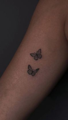 two butterflies tattoo on the arm