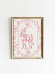 a pink and white drawing of a horse is mounted on the wall above a mirror