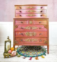 an old dresser is painted pink and gold